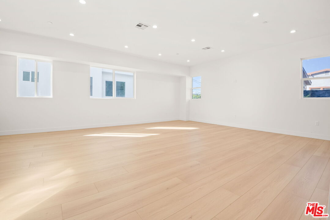 1707 South Burnside Avenue, Unit 1/2 Los Angeles, CA 90019 - Photo 7 of 30 an empty room with a empty space and window