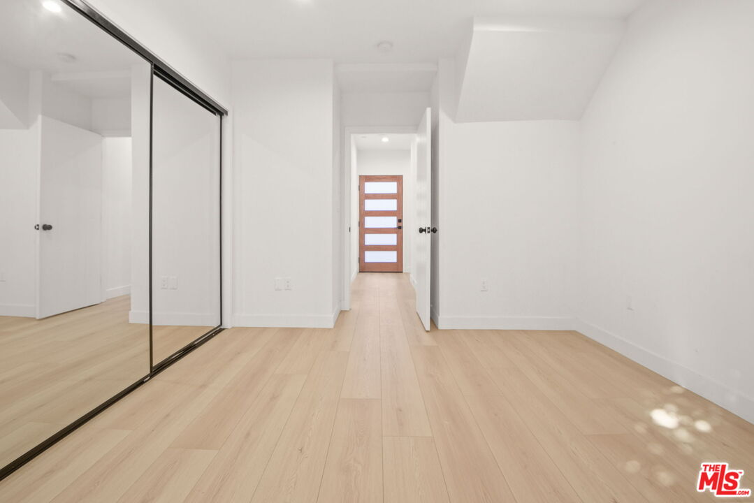 1707 South Burnside Avenue, Unit 1/2 Los Angeles, CA 90019 - Photo 10 of 30 a view of an empty room with wooden floor and closet