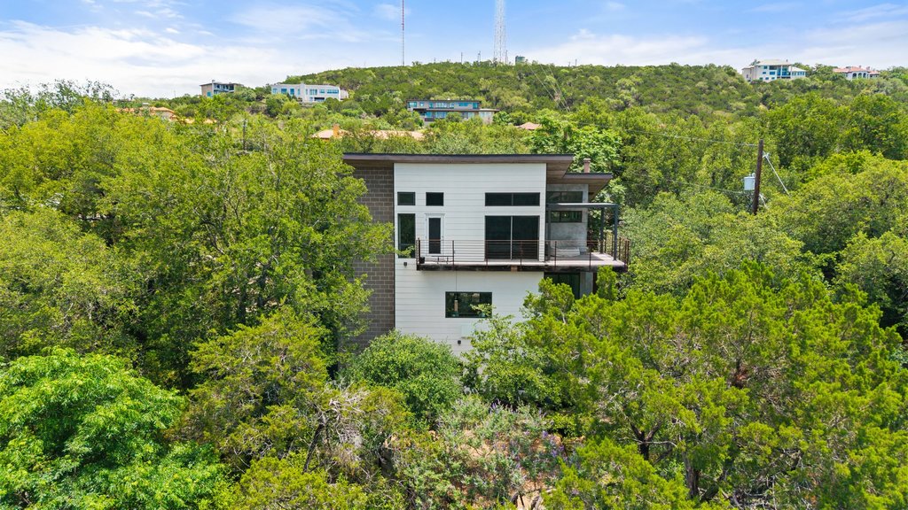 801 The High Road Austin, TX 78746 - Photo 36 of 40 a view of a house with a yard