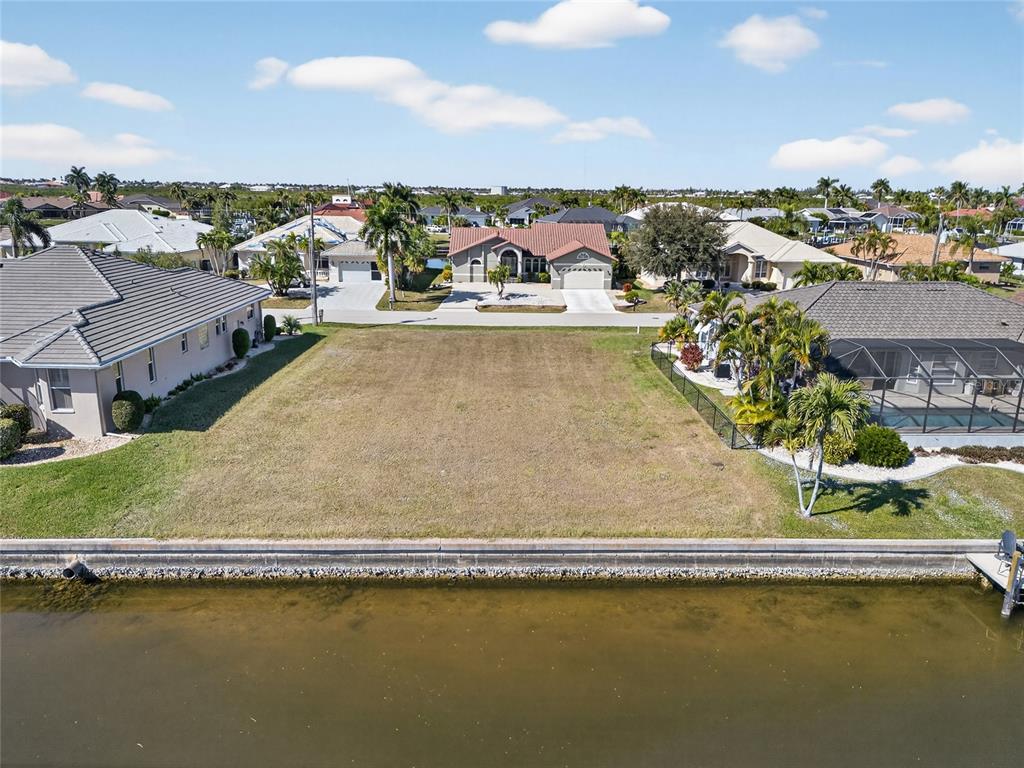 3938 San Pietro Court Punta Gorda, FL 33950 - Photo 5 of 8 an aerial view of residential houses with outdoor space