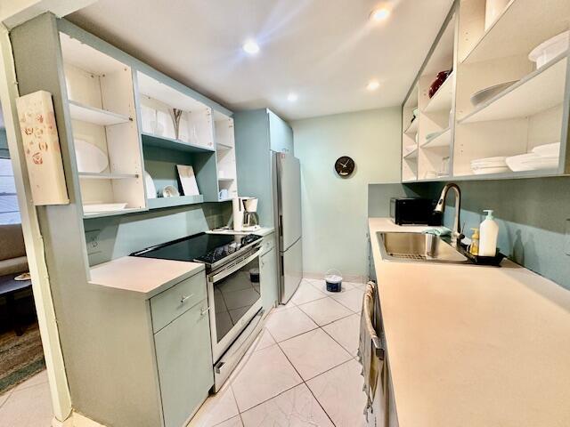 2070 Cornwall East Boca Raton, FL 33434 - Photo 6 of 30 a kitchen with stainless steel appliances a stove a sink a microwave a refrigerator a cabinets and wooden floor