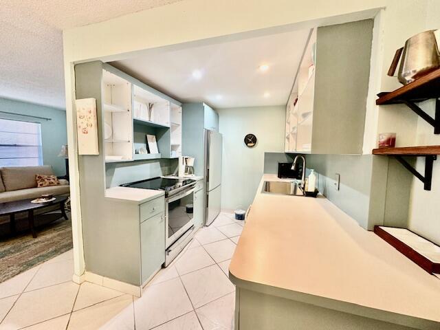 2070 Cornwall East Boca Raton, FL 33434 - Photo 7 of 30 a kitchen with stainless steel appliances a stove a sink and a refrigerator