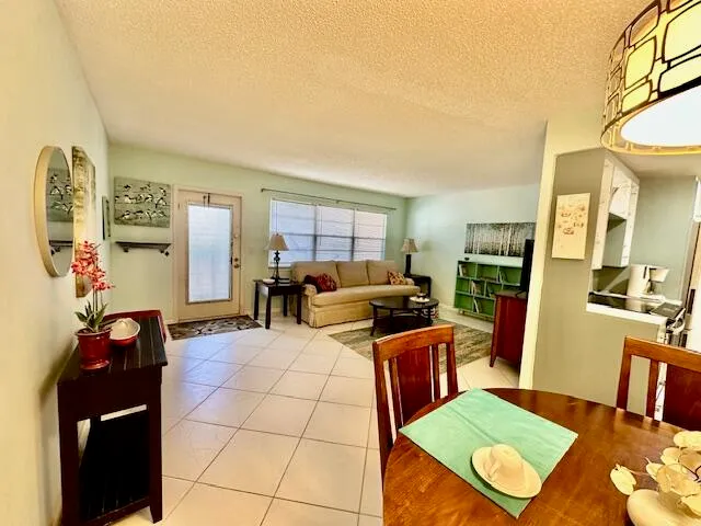 a living room with furniture a rug and a table