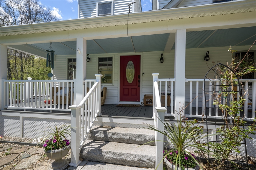 229 Parkerville Road Southborough, MA 01772 - Photo 8 of 38 a view of a house with large windows and flower plants