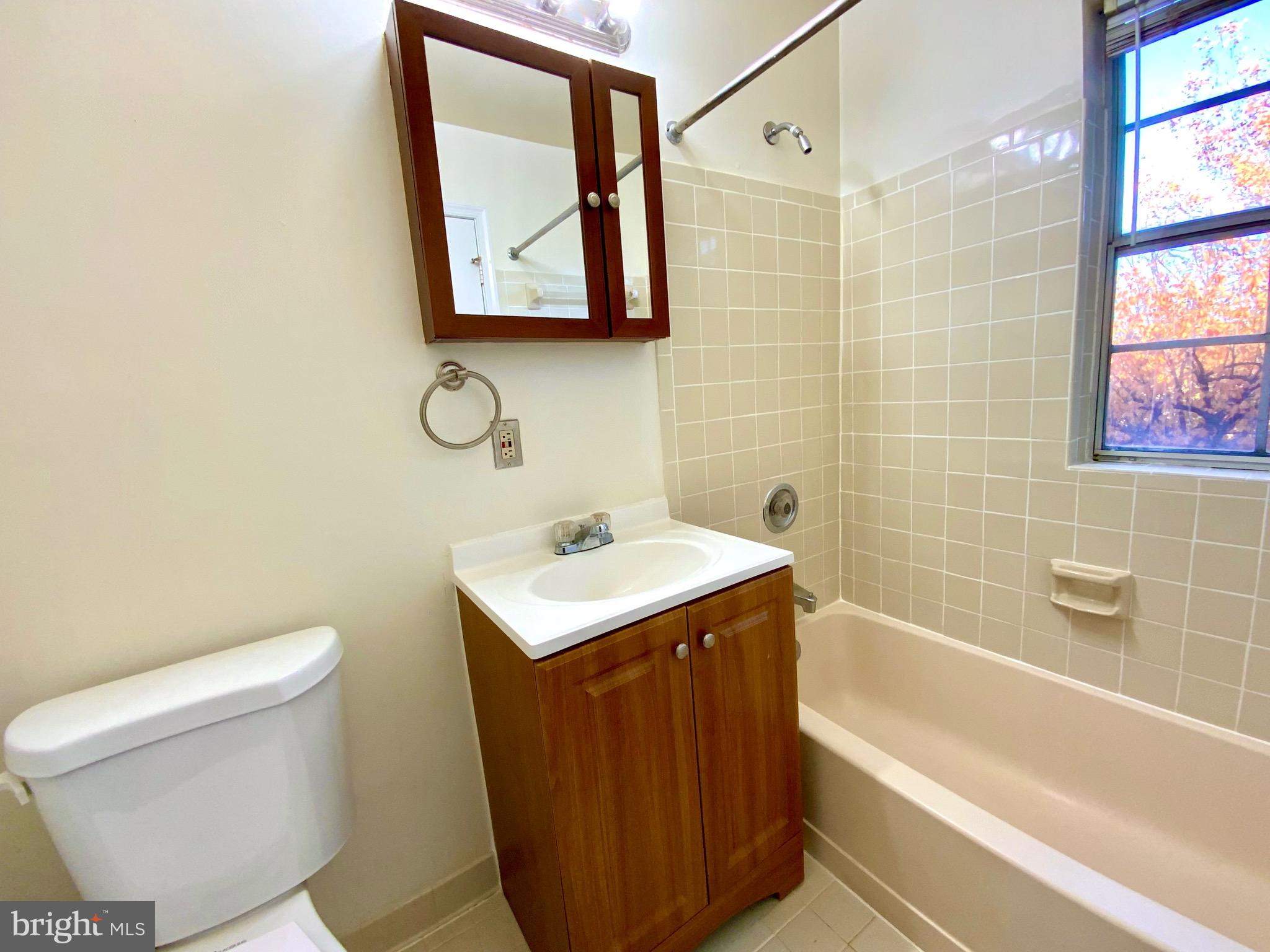 2007 Key Boulevard, Unit 589 Arlington, VA 22201 - Photo 9 of 16 a bathroom with a sink toilet and shower