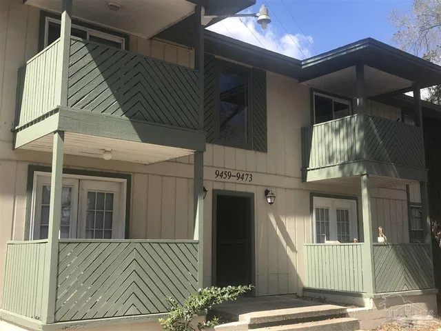 a view of a house with a door and wooden floor