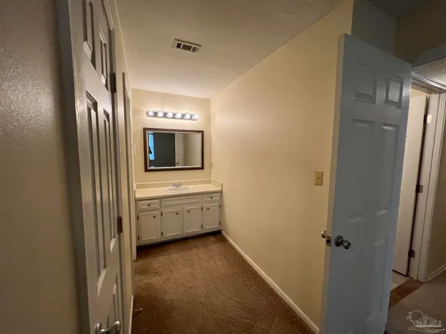 a bathroom with a sink a mirror and a bathtub