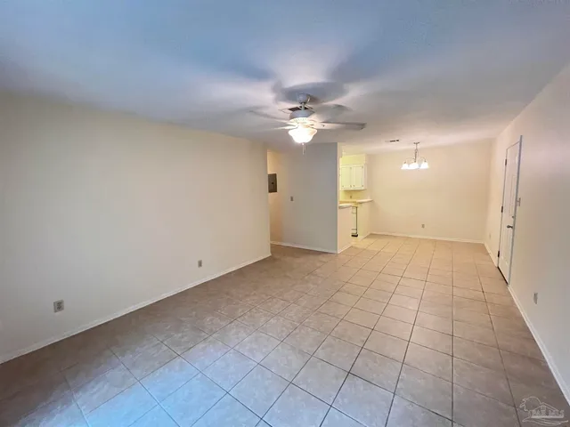 a view of an empty room with a ceiling fan