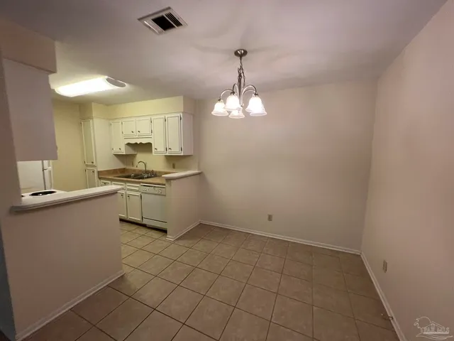 a kitchen with a sink cabinets and appliances