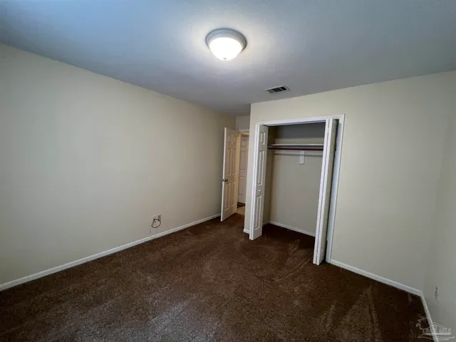 an empty room with closet area