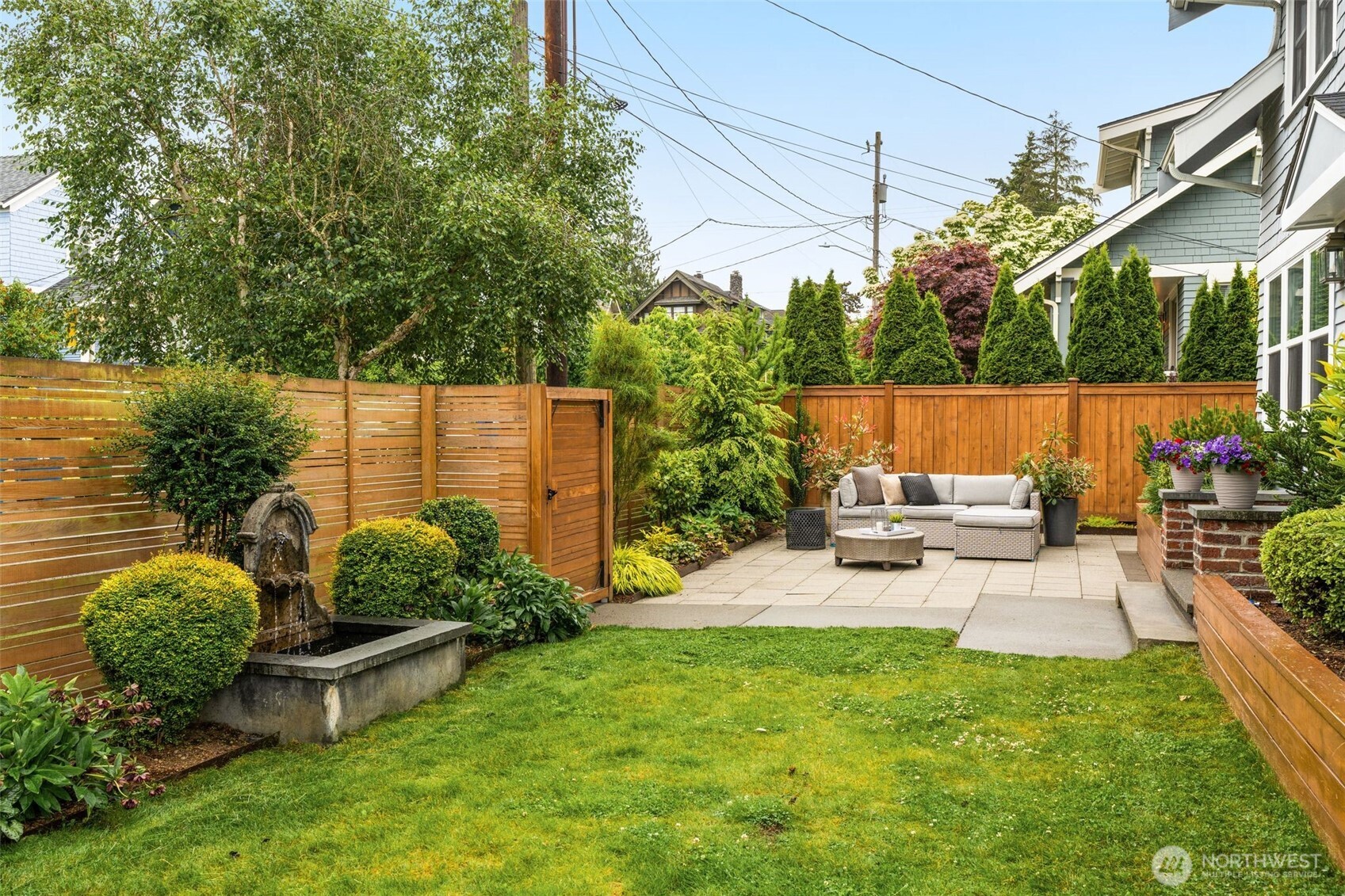 170 Lynn Street Seattle, WA 98109 - Photo 33 of 40 a view of a backyard with couches plants and large tree