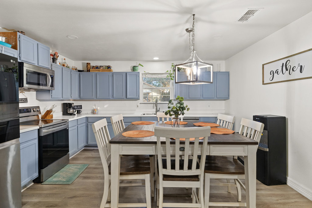 115 Rangeland Road Bastrop, TX 78602 - Photo 13 of 40 a view of a dining room with furniture kitchen and wooden floor
