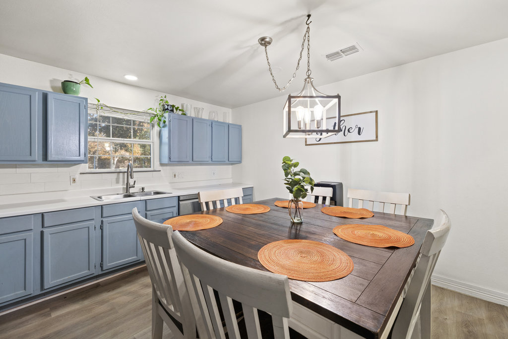 115 Rangeland Road Bastrop, TX 78602 - Photo 14 of 40 a dining room with wooden floor a sink and kitchen view