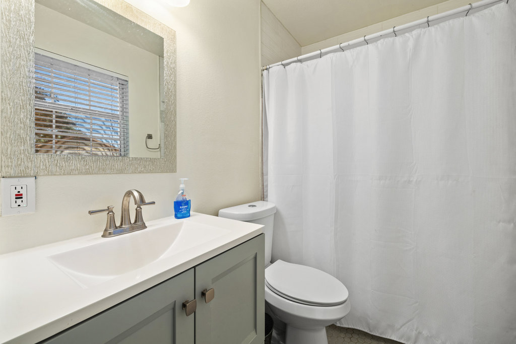 115 Rangeland Road Bastrop, TX 78602 - Photo 28 of 40 a bathroom with a sink a toilet and a mirror