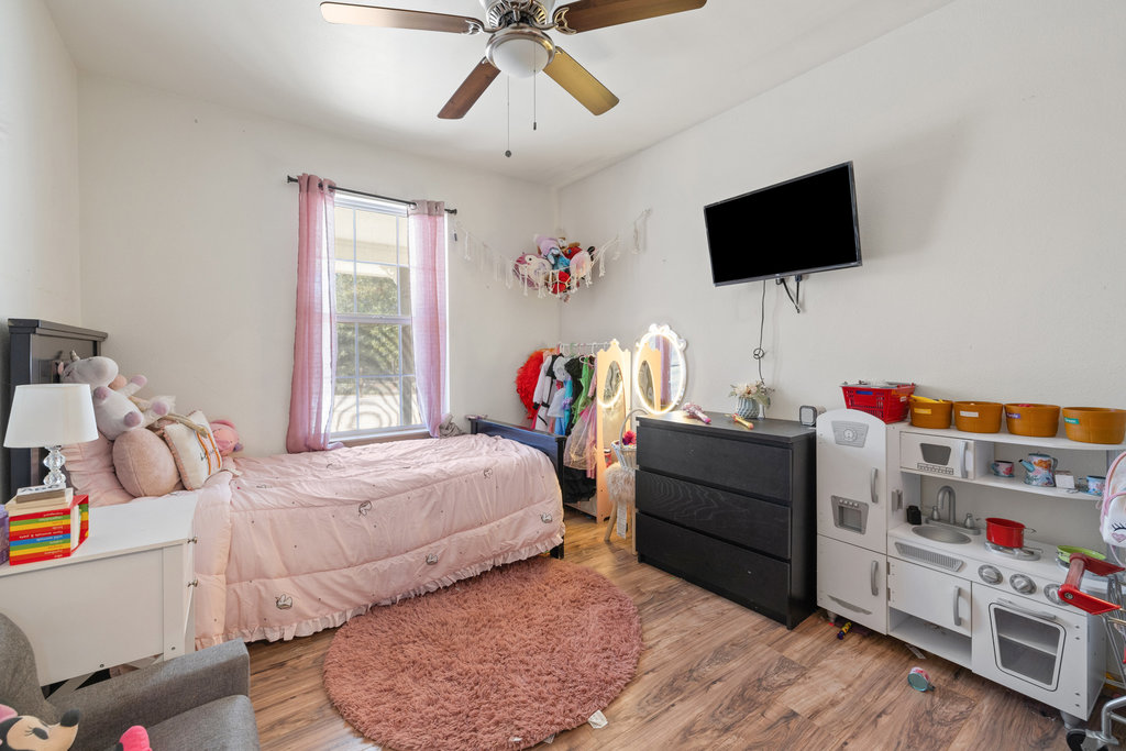 115 Rangeland Road Bastrop, TX 78602 - Photo 29 of 40 a bedroom with a bed and a flat screen tv