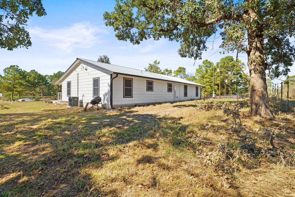 115 Rangeland Road Bastrop, TX 78602 - Photo 34 of 40 a view of a house with a yard