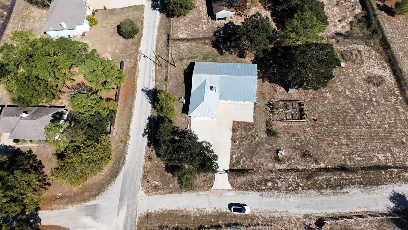 115 Rangeland Road Bastrop, TX 78602 - Photo 40 of 40 front view of a house with a yard and trees