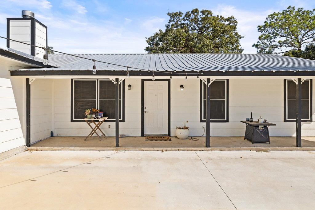 115 Rangeland Road Bastrop, TX 78602 - Photo 6 of 40 a backyard of a house with table and chairs