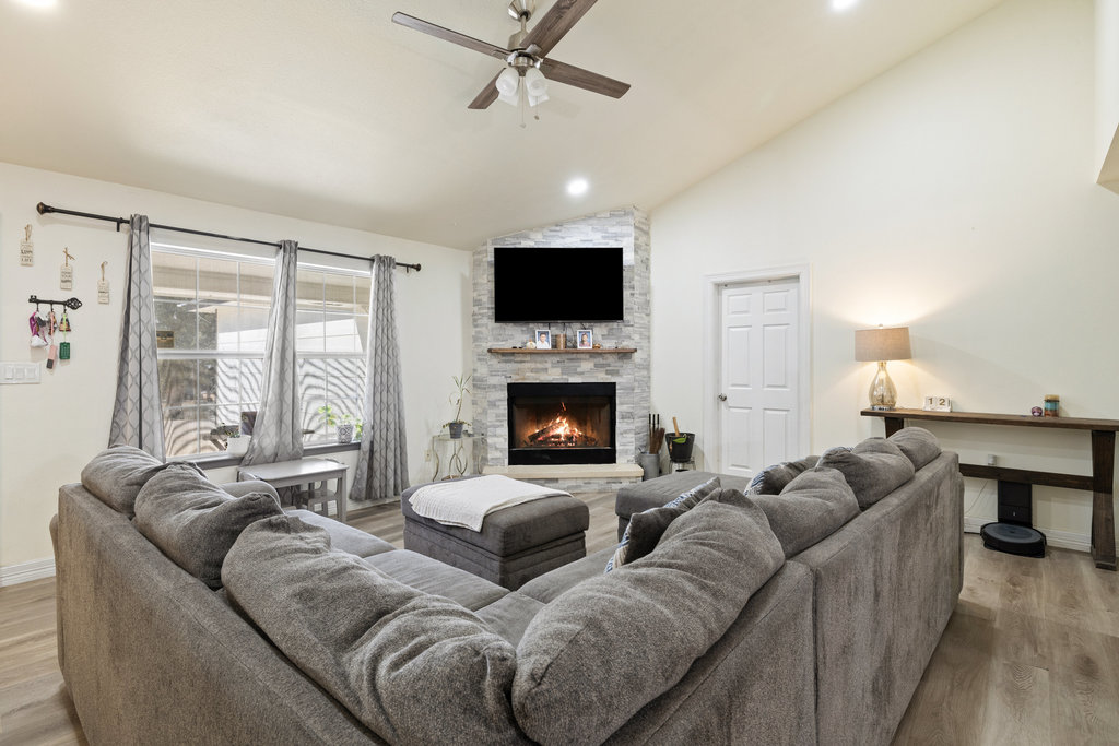 115 Rangeland Road Bastrop, TX 78602 - Photo 10 of 40 a living room with furniture fireplace and flat screen tv