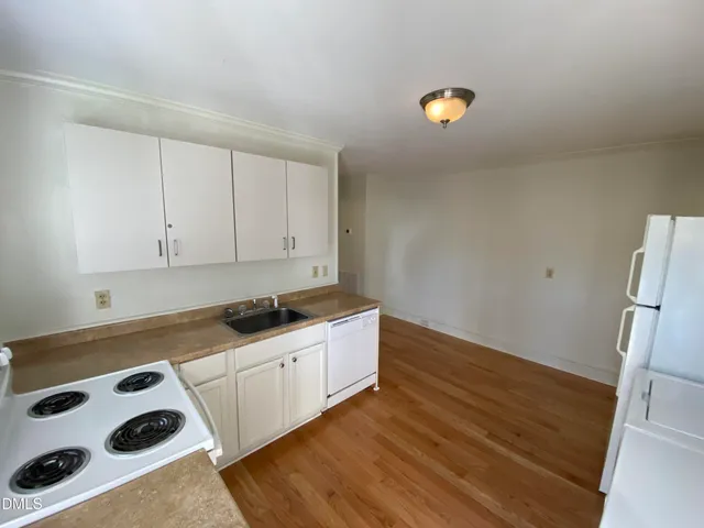 a kitchen with granite countertop a stove and a refrigerator