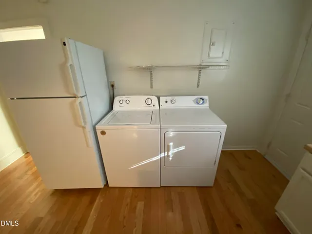 a kitchen with a sink a stove and white cabinets