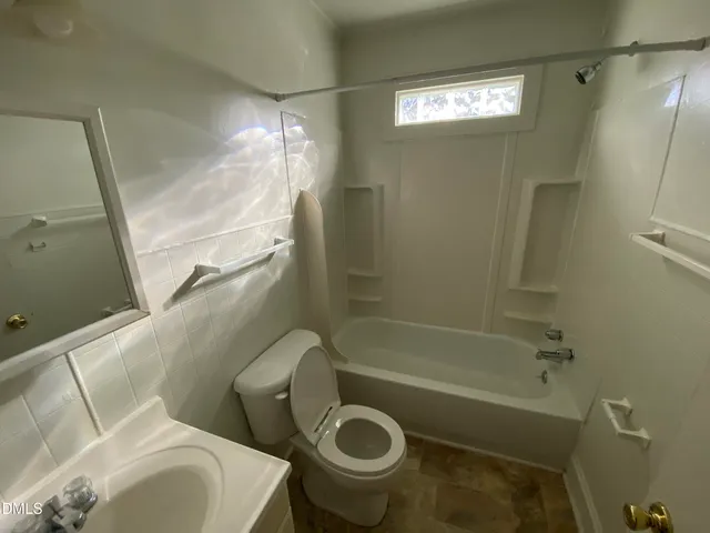 a utility room with wooden floor washer and dryer