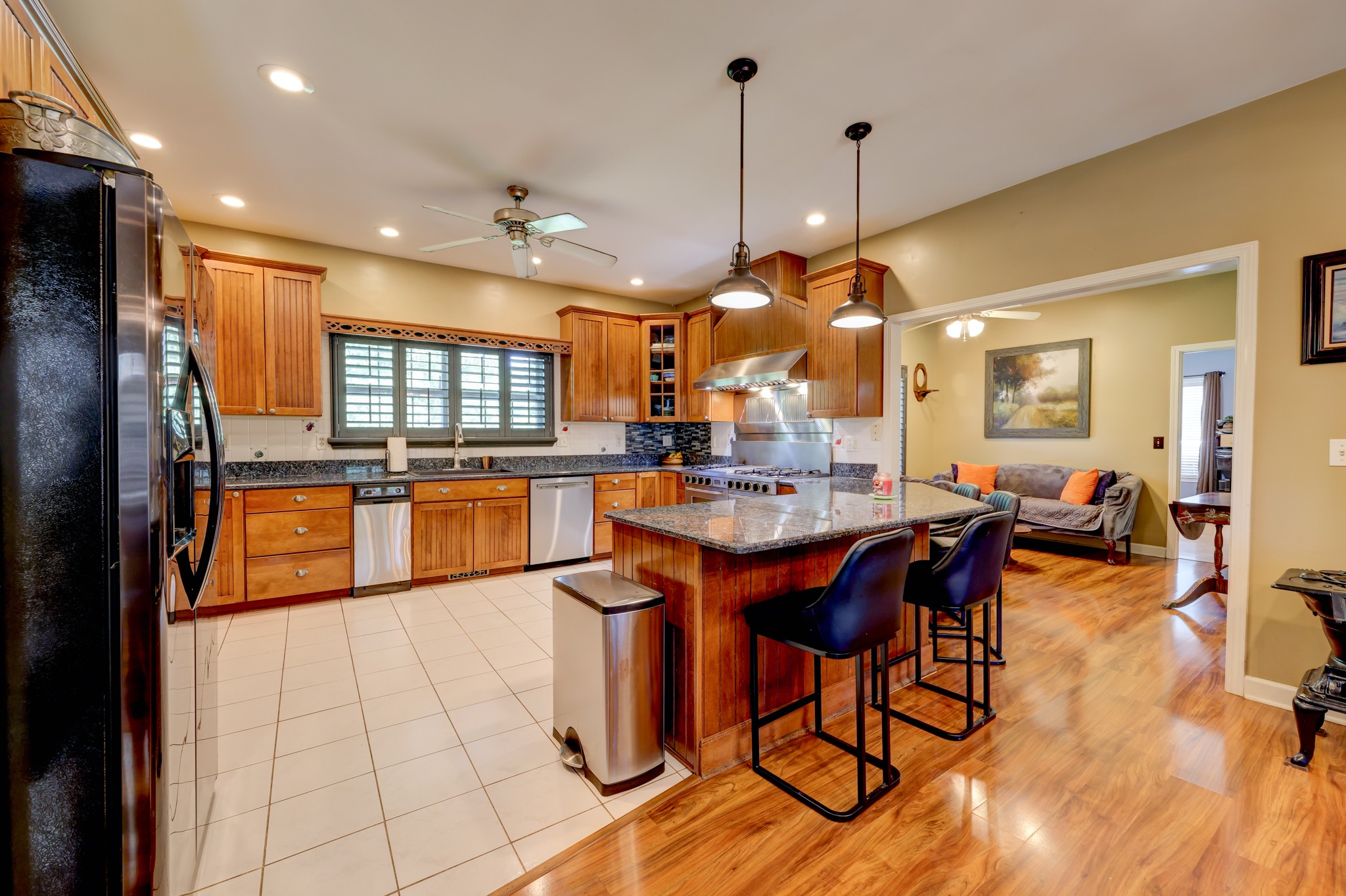 2251 Davidson Graveyard Road Clarksville, TN 37043 - Photo 34 of 78 a kitchen with stainless steel appliances granite countertop a refrigerator a sink dishwasher a dining table and chairs with wooden floor