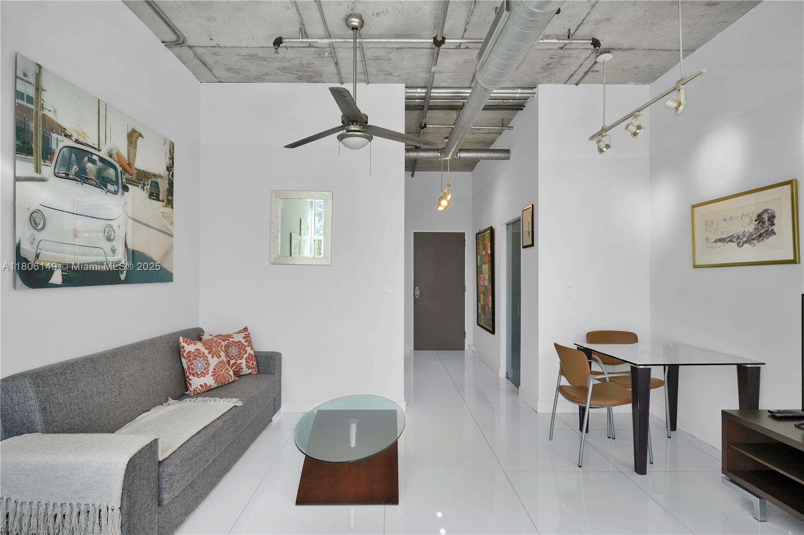 2001 Biscayne Boulevard, Unit 3213 Miami, FL 33137 - Photo 5 of 31 a living room with furniture and a chandelier