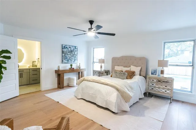 a bedroom with a large bed and a chandelier
