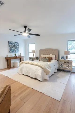 a bedroom with a large bed and a chandelier