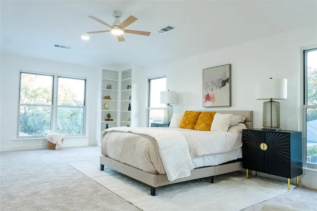 a bedroom with a large bed and a large window