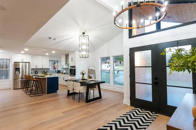 a living room with furniture and a chandelier