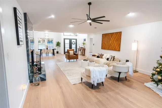 a living room with furniture and a chandelier