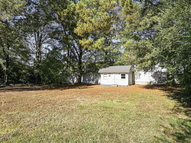a house that has a tree in front of it