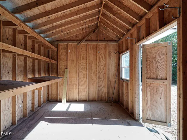 a view of an empty room with wooden walls