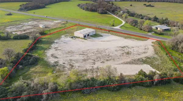 an aerial view of a house with a yard basket ball court and outdoor seating