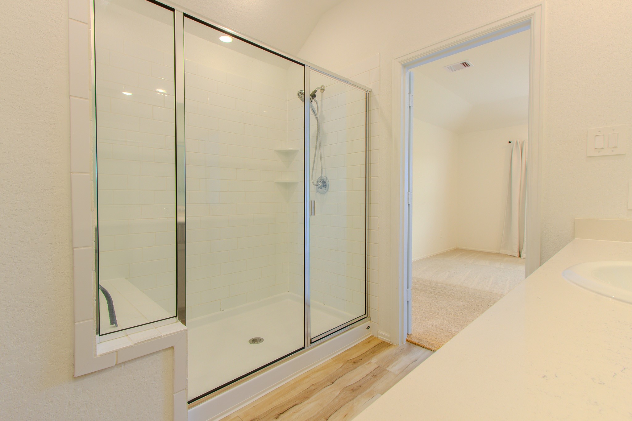 3113 Catalonion Court Conroe, TX 77301 - Photo 25 of 45 a bathroom with a glass shower door
