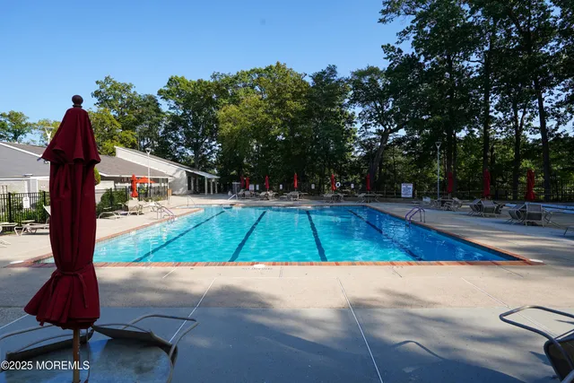 a view of backyard with swimming pool and outdoor seating