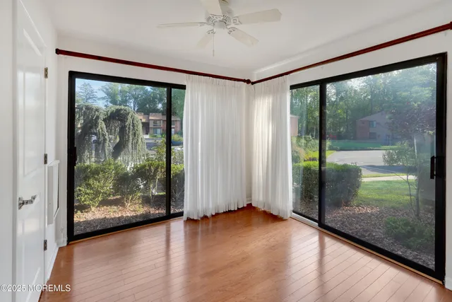an empty room with wooden floor and door