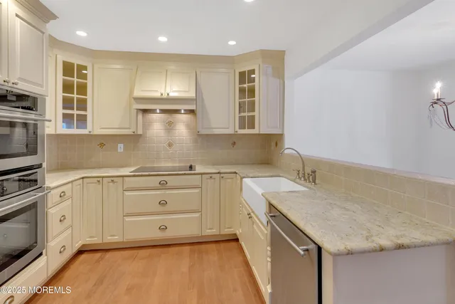 a kitchen with a stove a sink and a refrigerator