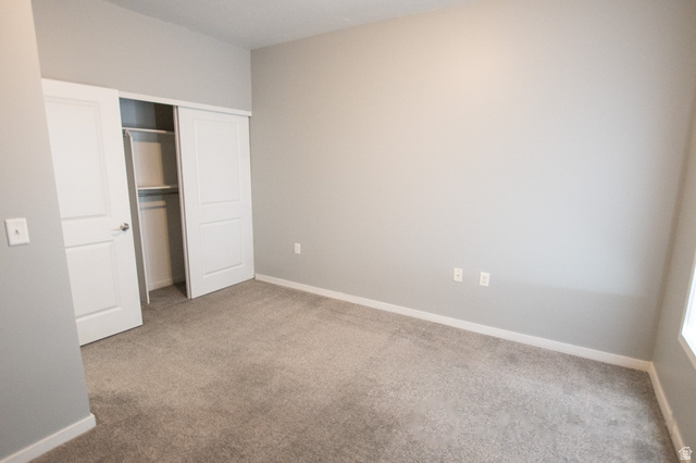 2150 South Main Street, Unit R405 Salt Lake City, UT 84115 - Photo 19 of 20 Carpeted room featuring a white trim baseboard, light gray walls, and a recessed ceiling light