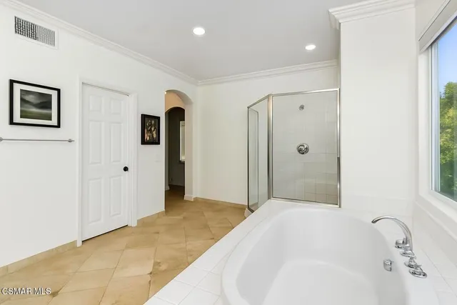 a bathroom with a bathtub and shower