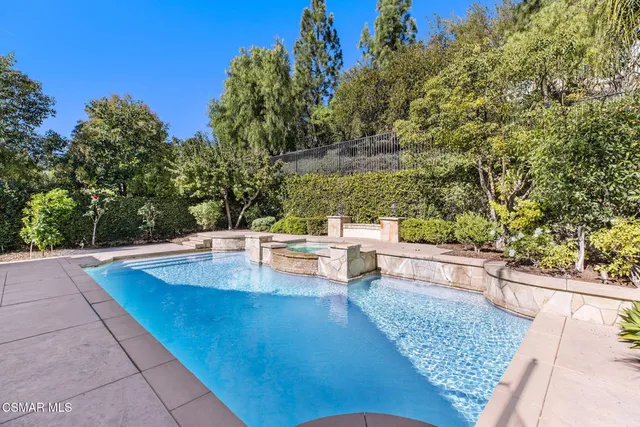 swimming pool view with a seating space