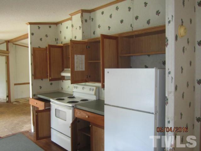1492 Glenn Fogleman Road Rougemont, NC 27572 - Photo 12 of 24 a kitchen with stainless steel appliances a refrigerator sink and cabinets