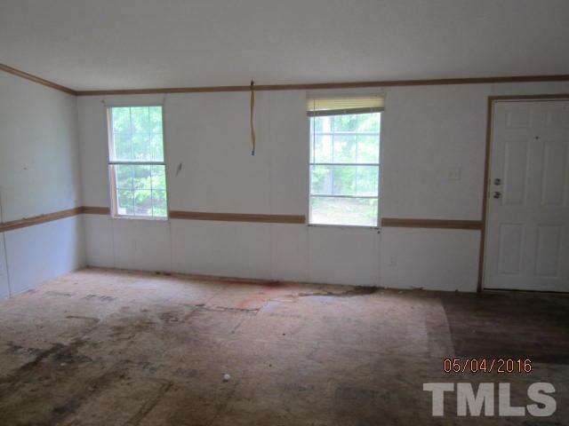 1492 Glenn Fogleman Road Rougemont, NC 27572 - Photo 13 of 24 an empty room with wooden floor and windows
