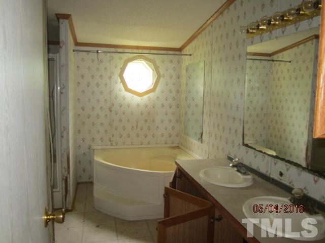 1492 Glenn Fogleman Road Rougemont, NC 27572 - Photo 16 of 24 a bathroom with a sink and a mirror
