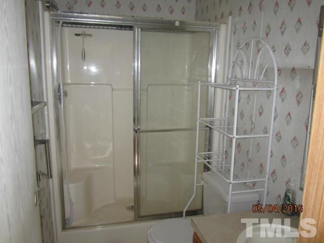 1492 Glenn Fogleman Road Rougemont, NC 27572 - Photo 21 of 24 a bathroom with a glass shower door