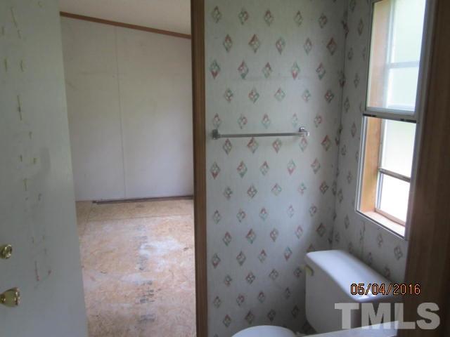 1492 Glenn Fogleman Road Rougemont, NC 27572 - Photo 22 of 24 a bathroom with a toilet and a shower
