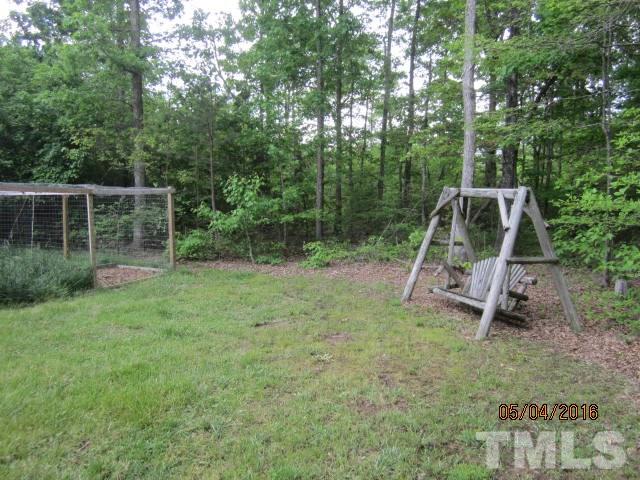 1492 Glenn Fogleman Road Rougemont, NC 27572 - Photo 7 of 24 a backyard of a house with trampoline and entertaining space
