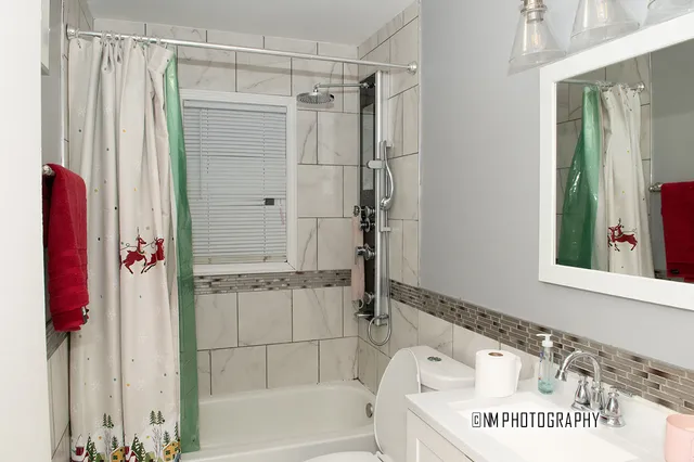 a bathroom with a shower and a sink